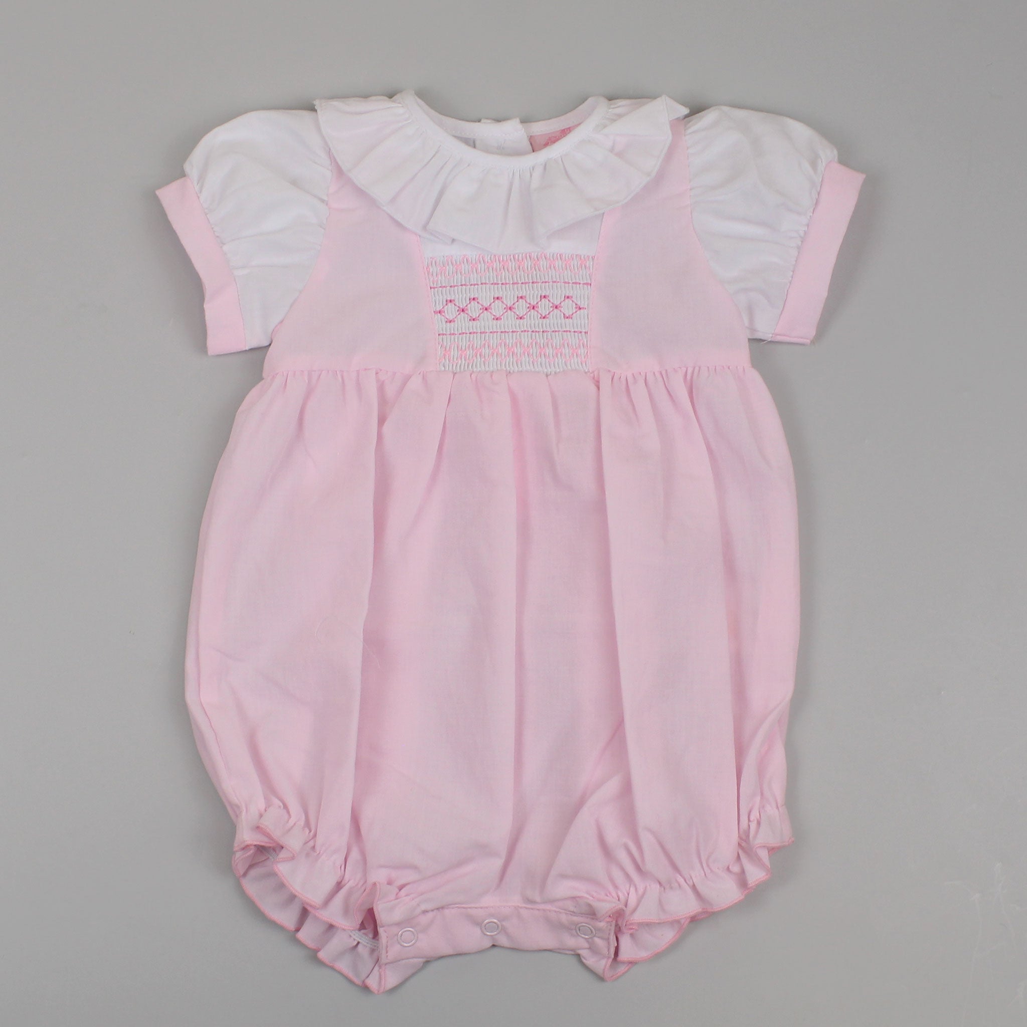 baby girls outfit with smocked design in pink with smocked collar