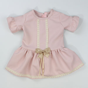 Baby girls dress with lace and bows in pink