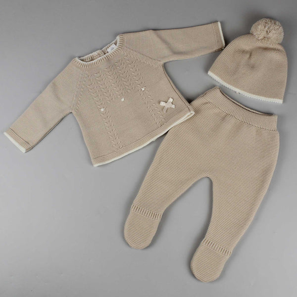 beige three piece knitted outfit with jumper trousers and hat