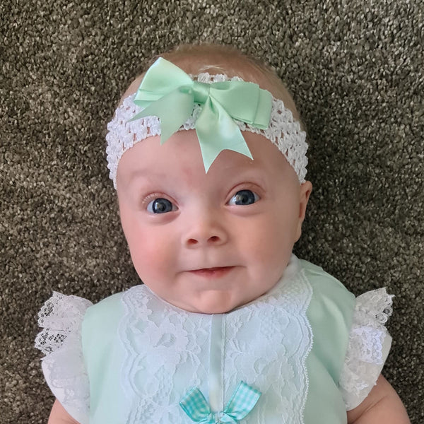 girls white head band with green bow
