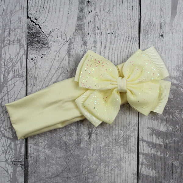 pale yellow headband with sparkly bow