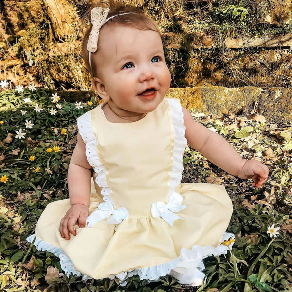 yellow baby girls dress with two white bows