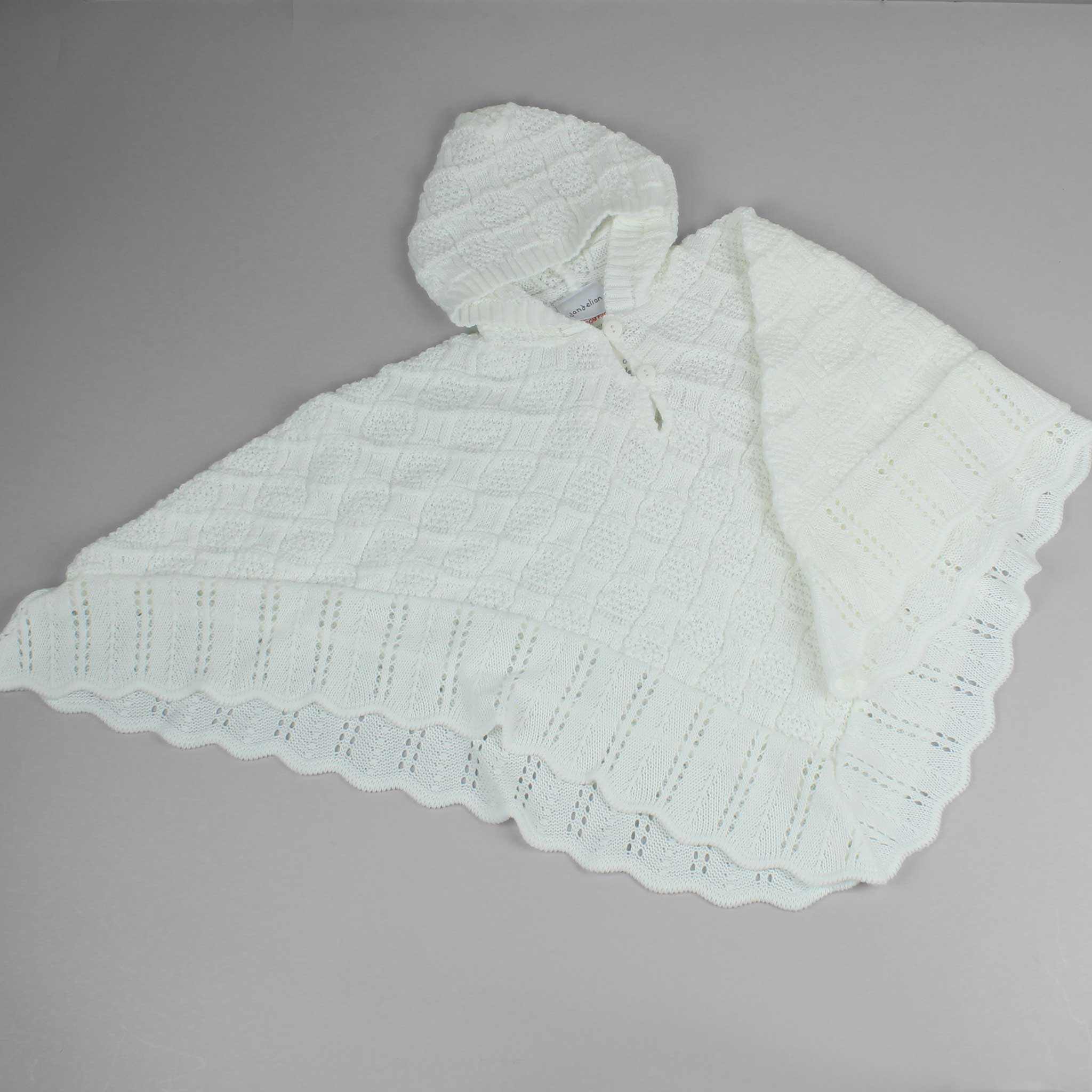 white knitted baby poncho
